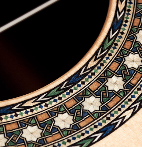 A close-up of the rosette of a 2022 Miguel Angel Gutierrez classical guitar made of spruce and Indian rosewood.