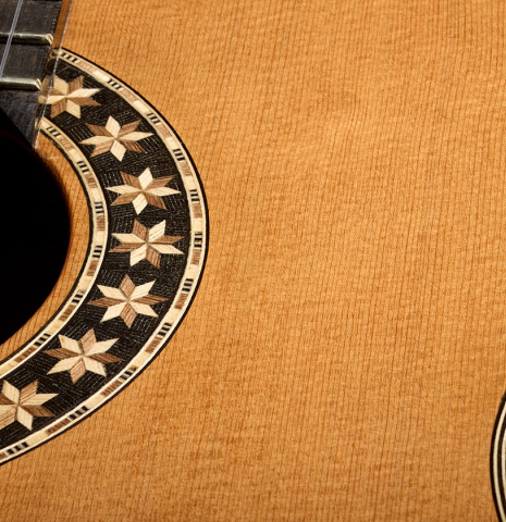 The soundboard and rosette of a 2026 Oscar Munoz classical guitar made of cedar and Makassar ebony