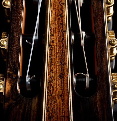 The headstock veneer and tuning machines of a 2026 Oscar Munoz classical guitar made of cedar and Makassar ebony