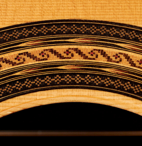 A close-up of the rosette of a 2020 Stefan Nitschke &quot;1912 Manuel Ramirez&quot; classical guitar made of spruce and CSA rosewood. 