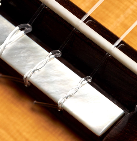 The bridge and tie block of a 2020 Stefan Nitschke &quot;1912 Manuel Ramirez&quot; classical guitar made of spruce and CSA rosewood. 