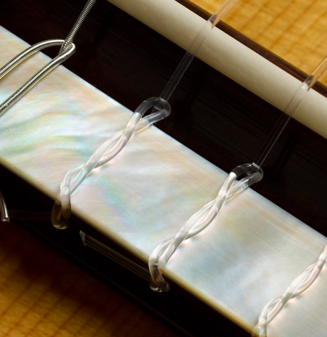 The bridge, tie-block and saddle of a 2024 Stefan Nitschke "Santos" classical guitar made of spruce and CSA rosewood