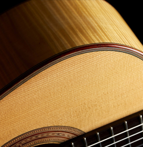 The soundboard, side, binding and purfling of a 2000 Fritz Ober classical guitar made of spruce and maple