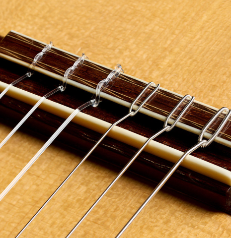 The bridge, tie-block and saddle of a 1997 Fritz Ober classical guitar made of spruce and CSA rosewood