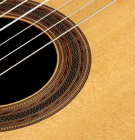 The soundboard and rosette detail of a 1997 Fritz Ober classical guitar made of spruce and CSA rosewood