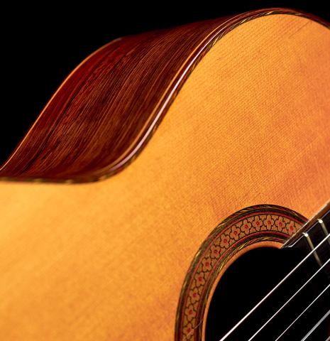 The soundboard and side of a 1964 Jose Oribe classical guitar made of spruce and CSA rosewood