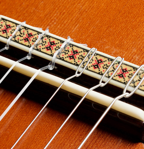 The bridge, tie-block and saddle of a 1977 Jose Oribe "Calidad Suprema" classical guitar made of cedar and CSA rosewood