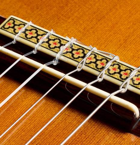 The bridge, tie-block and saddle of a 1985 Jose Oribe "Calidad Suprema" classical guitar made of cedar and CSA rosewood