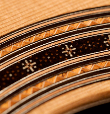 A close-up of the rosette of a 2021 Darragh O'Connell classical guitar made of cedar and Indian rosewood