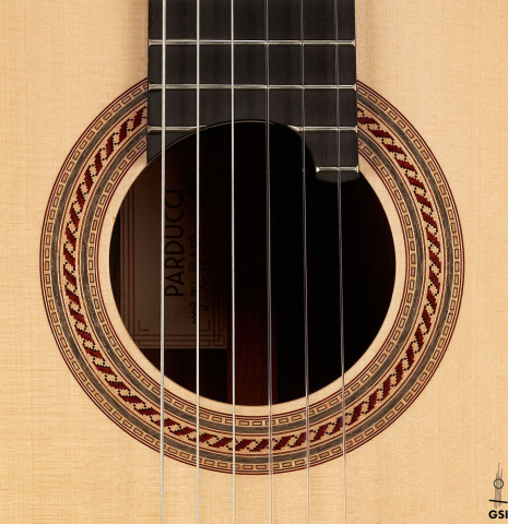 This is the rosette of a 2023 Alexis Parducci classical guitar made with spruce and African rosewood.