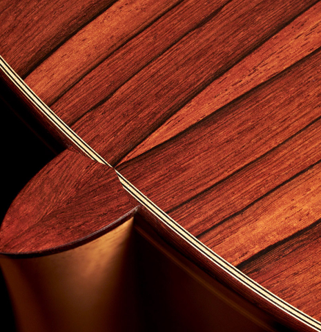 This is the heel, binding and back of a 2023 Alexis Parducci classical guitar made with spruce and African rosewood.