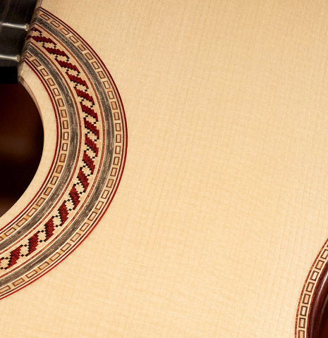 This is the soundboard and rosette of a 2023 Alexis Parducci classical guitar made with spruce and African rosewood.