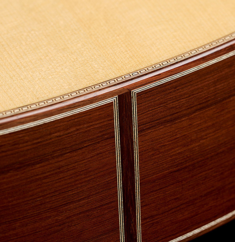 The top and sides at the foot of a 2026 Alexis Parducci classical guitar made of spruce and African rosewood