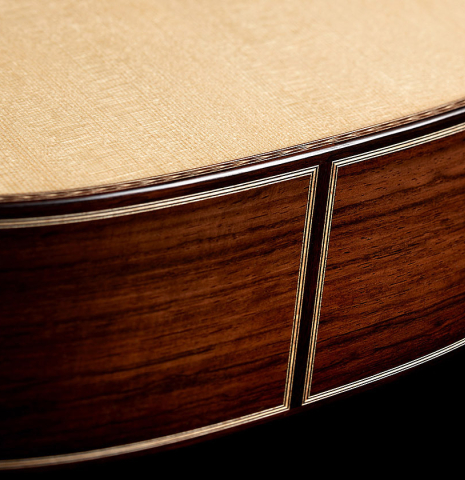The sides at the foot of a 2024 Alexis Parducci "Llobet" classical guitar made of spruce and CSA rosewood