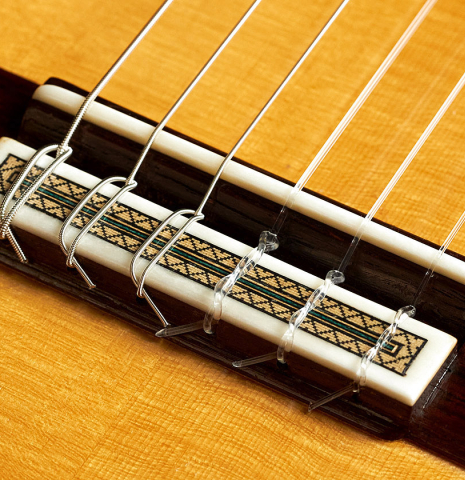 The bridge, tie-block and saddle of a 2010 Teodoro Perez "Especial" classical guitar made of spruce and CSA rosewood