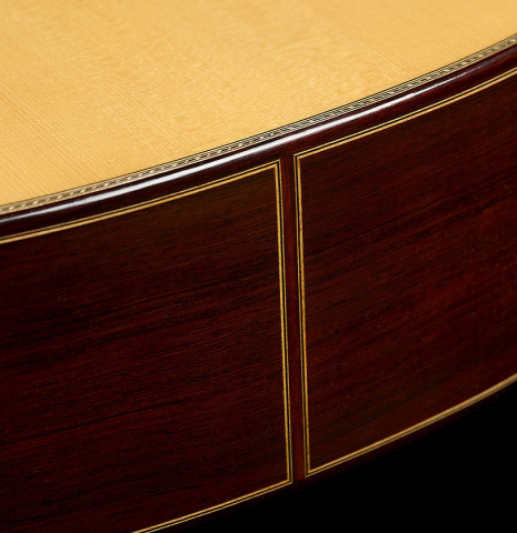 The sides at the foot of a 2025 Teodoro Perez "Concierto" classical guitar made of spruce and African rosewood