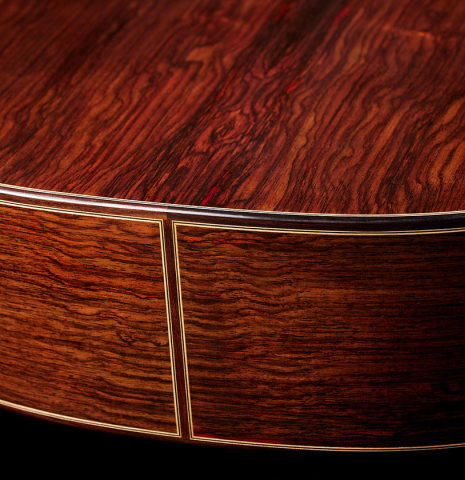 The back and sides at the foot of a 2024 Teodoro Perez "Concierto" classical guitar made of cedar and Indian rosewood.