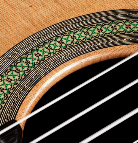 Detail of the rosette of a 2024 Teodoro Perez "Concierto" classical guitar made of cedar and Indian rosewood.