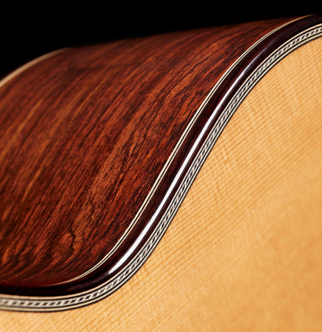 The top binding and purflings of a 2024 Teodoro Perez "Concierto" classical guitar made of cedar and Indian rosewood.