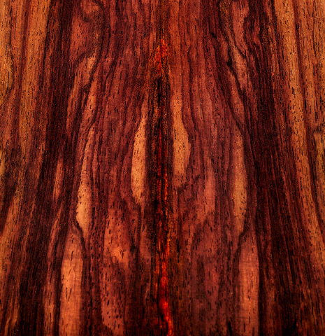 The wild grain patterns in the back of a 2026 Teodoro Perez "Concierto" classical guitar made of cedar and Indian rosewood