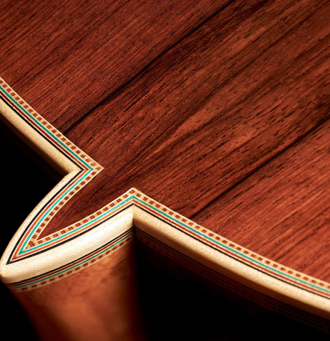 Closeup of back, sides, heel, bindings and purflings of a 2023 Teodoro Perez "Epecial" classical guitar made of spruce and African rosewood.
