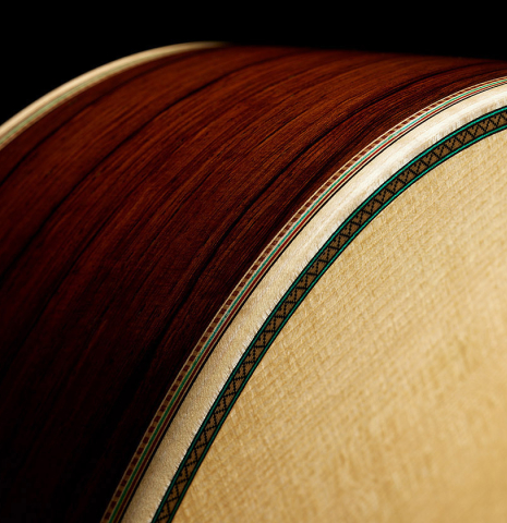 The top binding and purfling of a 2025 Teodoro Perez "Especial" classical guitar made of spruce and African rosewood.