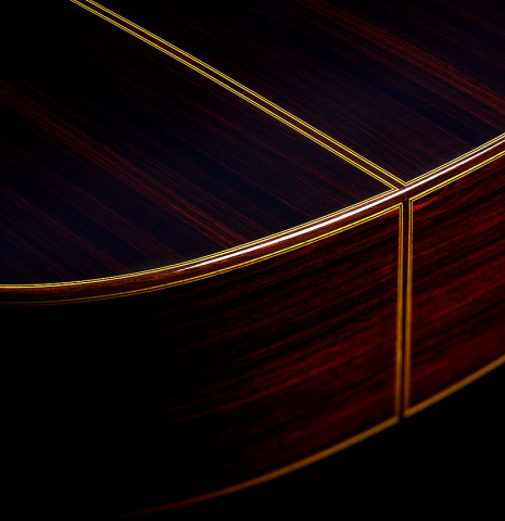 The sides at the foot of a 2025 Teodoro Perez "Madrid" classical guitar made of cedar and Indian rosewood