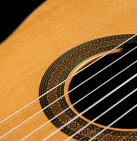 The top and rosette detail of a 2025 Teodoro Perez "Madrid" classical guitar made of cedar and Indian rosewood