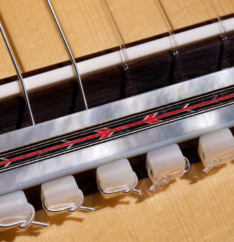 The bridge, tie-block and saddle of a 2020 Teodoro Perez "Especial Aniversario" classical guitar made of spruce and cocobolo