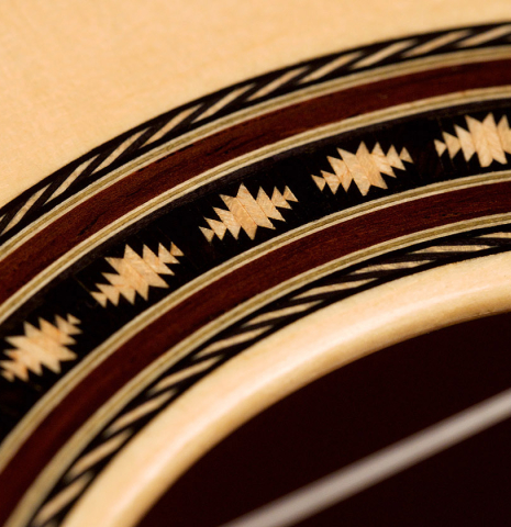 A close-up of the rosette of a 2021 Erez Perelman classical guitar made of spruce and cypress