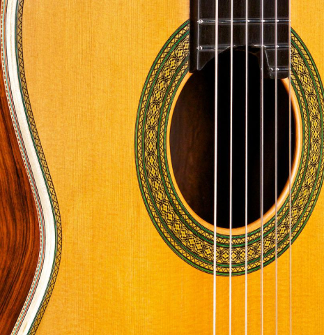 The soundboard and rosette of a 2015 Teodoro Perez "Especial Maple" classical guitar made of cedar and CSA rosewood