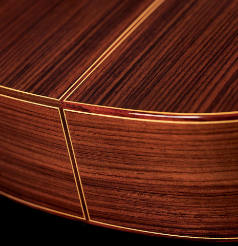 The back and sides at the foot of a 2023 Teodoro Perez "Estudio C-650" classical guitar made of cedar and Indian rosewood.