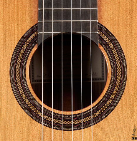 The rosette of a 2023 Teodoro Perez "Estudio C-650" classical guitar made of cedar and Indian rosewood.