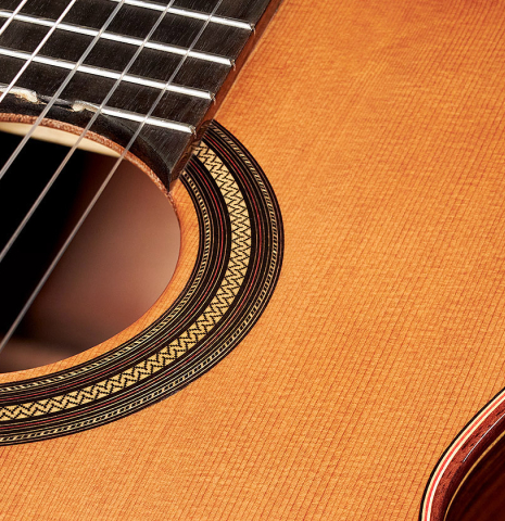 The top rosette detail of a 2023 Teodoro Perez "Estudio C-650" classical guitar made of cedar and Indian rosewood.