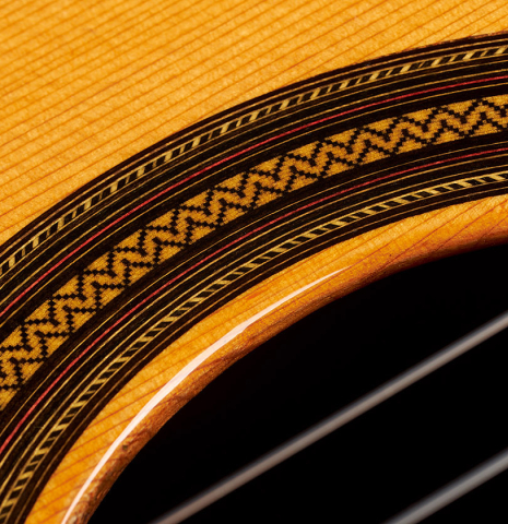The top rosette detail of a 2024 Teodoro Perez "Estudio C-650" classical guitar made of cedar and Indian rosewood.