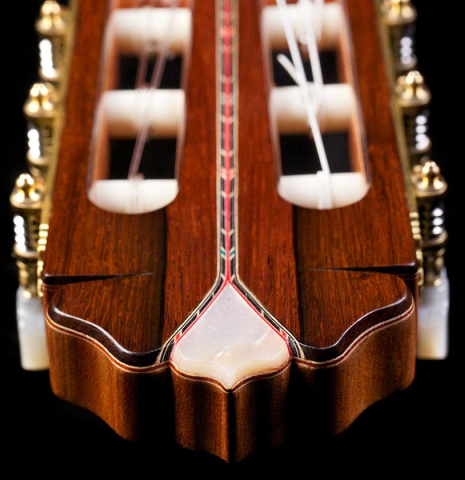The headstock with inlays and tuning machines of a 2016 Teodoro Perez "50th Anniversary" classical guitar made of cedar and CSA rosewood