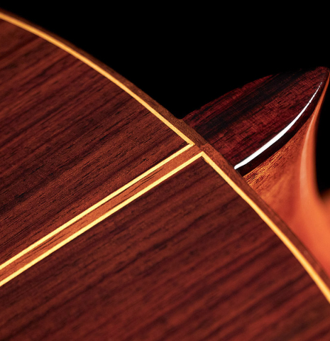 The heel of a 2023 Teodoro Perez &quot;Estudio C-650&quot; classical guitar made of spruce and Indian rosewood.