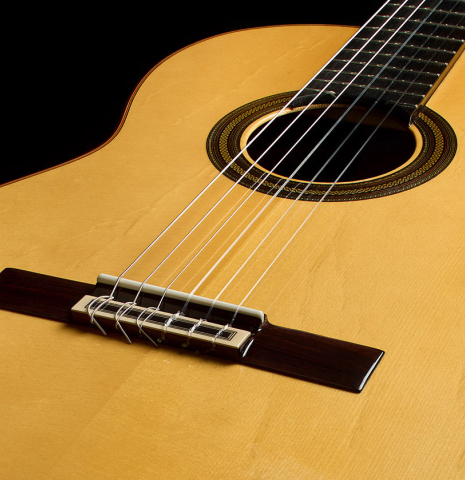 The top, bridge, tie-block and saddle of a 2025 Teodoro Perez "Estudio C-650" classical guitar made of spruce and Indian rosewood