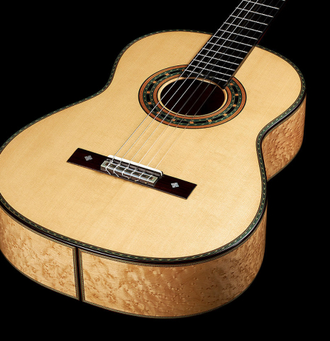 The top and sides of a 2024 Teodoro Perez "1884 Torres - La Emperatriz" classical guitar made of spruce and maple