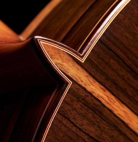 The back, sides and heel of a 2023 Sergio Perez "Segovia" model of classical guitar made of cedar and green ebony. 