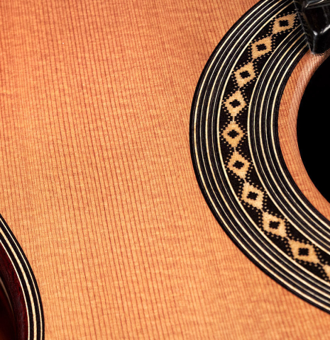 The soundboard and rosette of a 2023 Teodoro Perez "Antigua" classical guitar made of cedar and Indian rosewood.