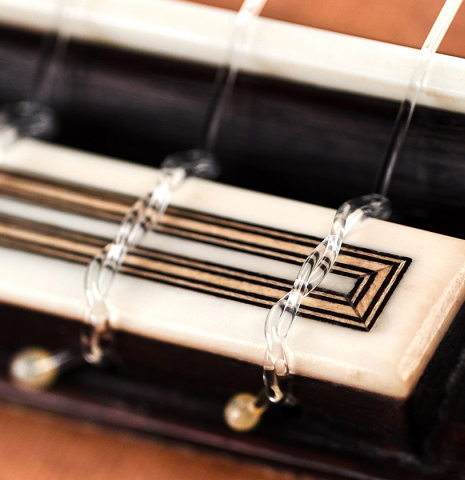 The tie block of a 2023 Teodoro Perez "Antigua" classical guitar made of cedar and Indian rosewood.