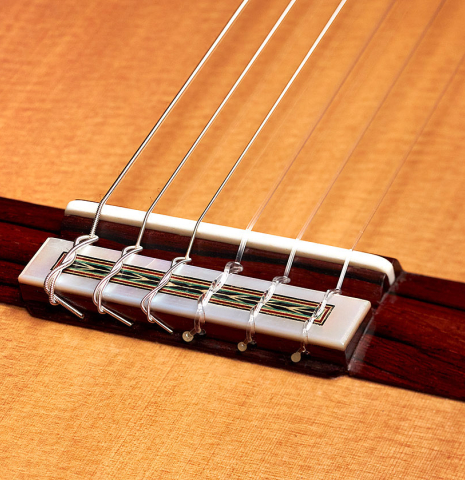 The bridge and saddle of a 2022 Teodoro Perez &quot;Especial&quot; classical guitar model made with cedar and Brazilian lacewood