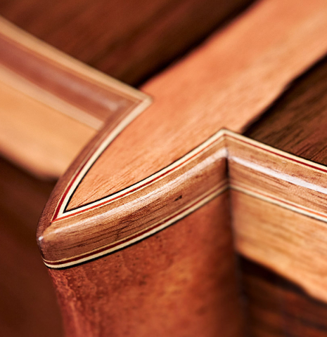 The heel of a 2023 Sergio Perez "Segovia" model of classical guitar made of spruce and green ebony. 