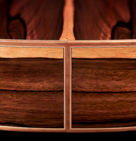 The lower bout of a 2023 Sergio Perez "Segovia" model of classical guitar made of spruce and green ebony. 