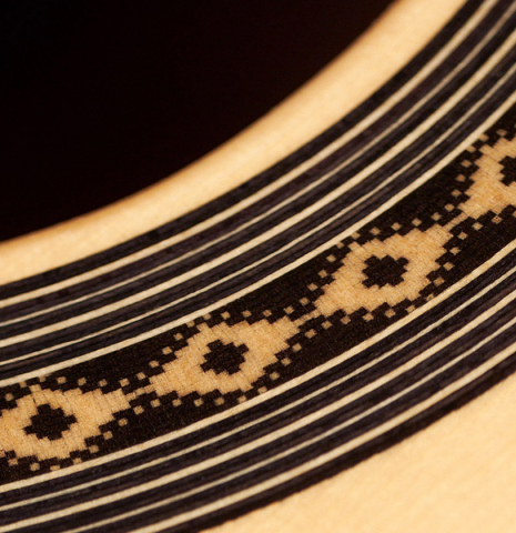 The soundboard and rosette of a 2023 Teodoro Perez "Antigua" classical guitar made of spruce and Indian rosewood.