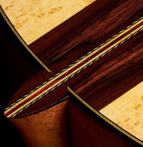 Closeup of the heel, center seam and back of a 2023 Erez Perelman classical guitar made of spruce and birdseye maple
