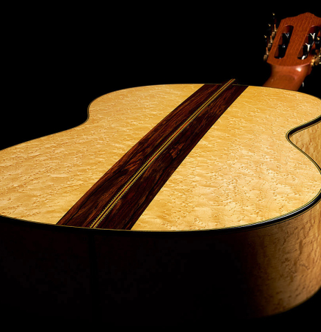 The back and sides at the foot of a 2023 Erez Perelman classical guitar made of spruce and birdseye maple