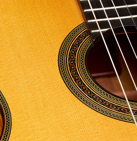 The soundboard and rosette of a 2007 Daryl Perry "Simplicio" classical guitar made with spruce and satinwood