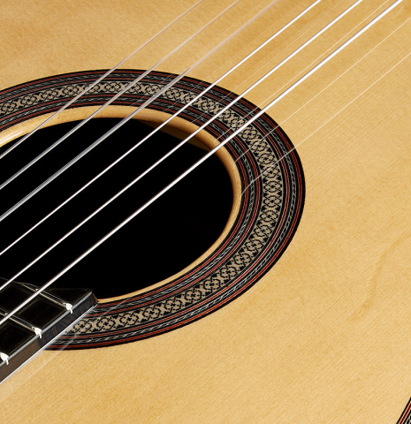 The soundboard and rosette detail of a 2024 Sergio Perez "Segovia" classical guitar made of spruce and Indian rosewood.